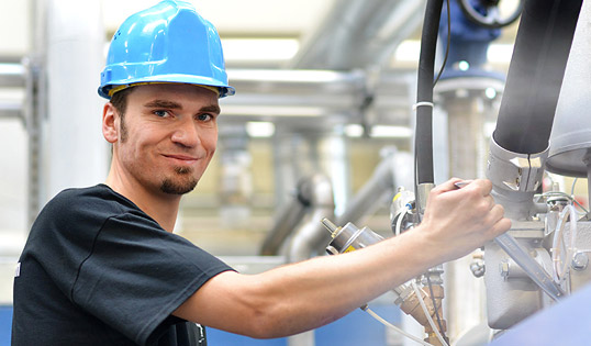 Happy worker using misting fan